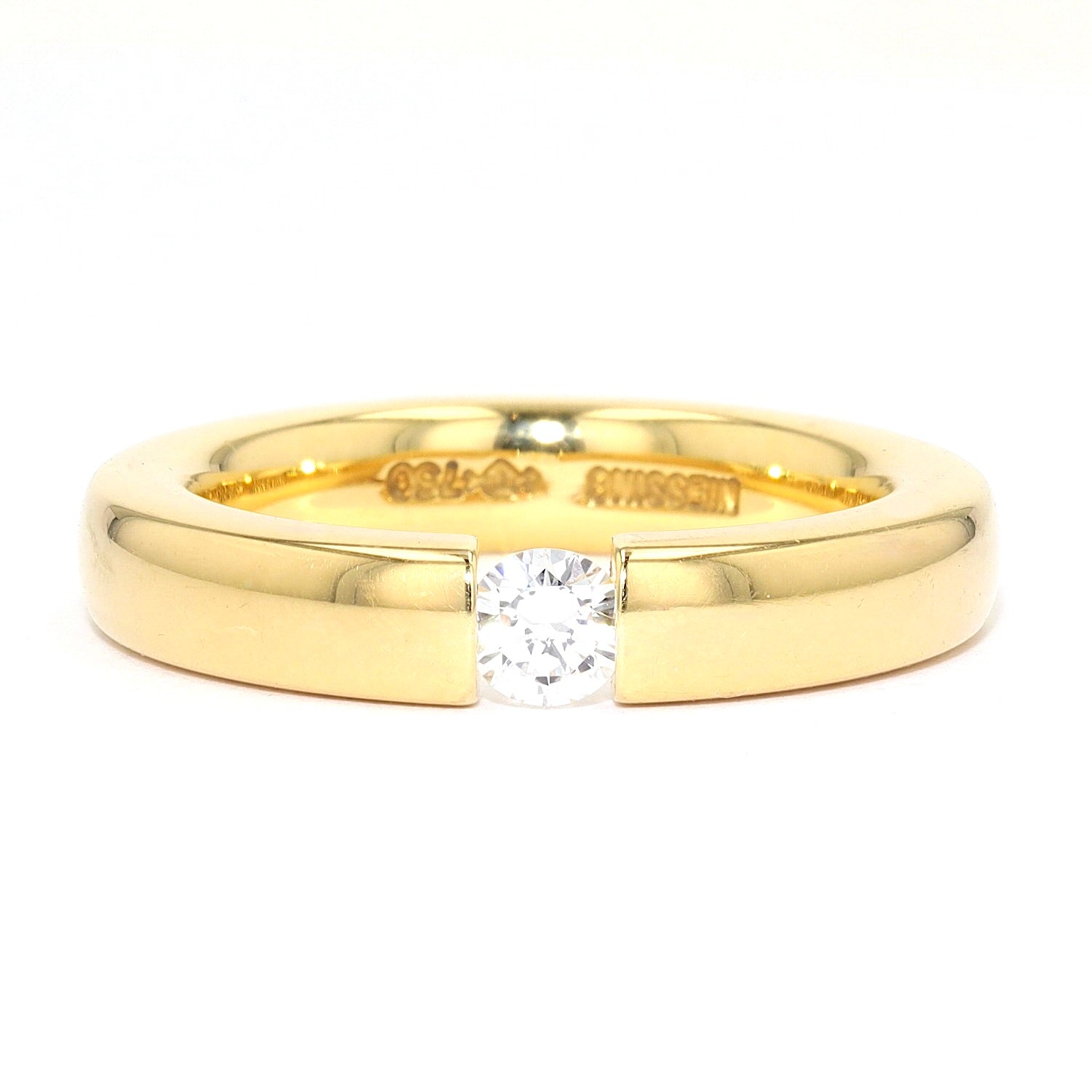 Niessing Spannring in 750er Gelbgold mit einem Brillanten ca. 0,20 ct, liegend frontal