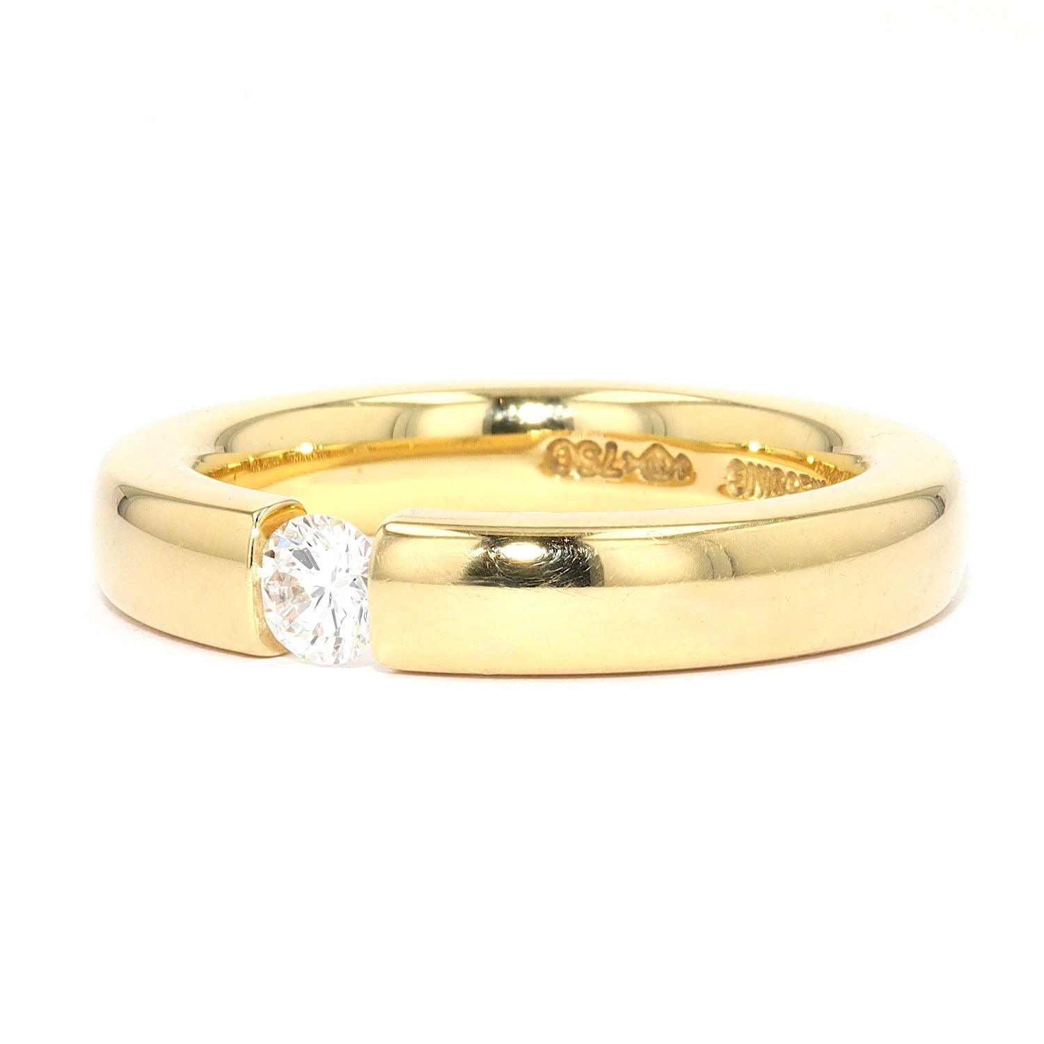 Niessing Spannring in 750er Gelbgold mit einem Brillanten ca. 0,20 ct, liegend links gedreht
