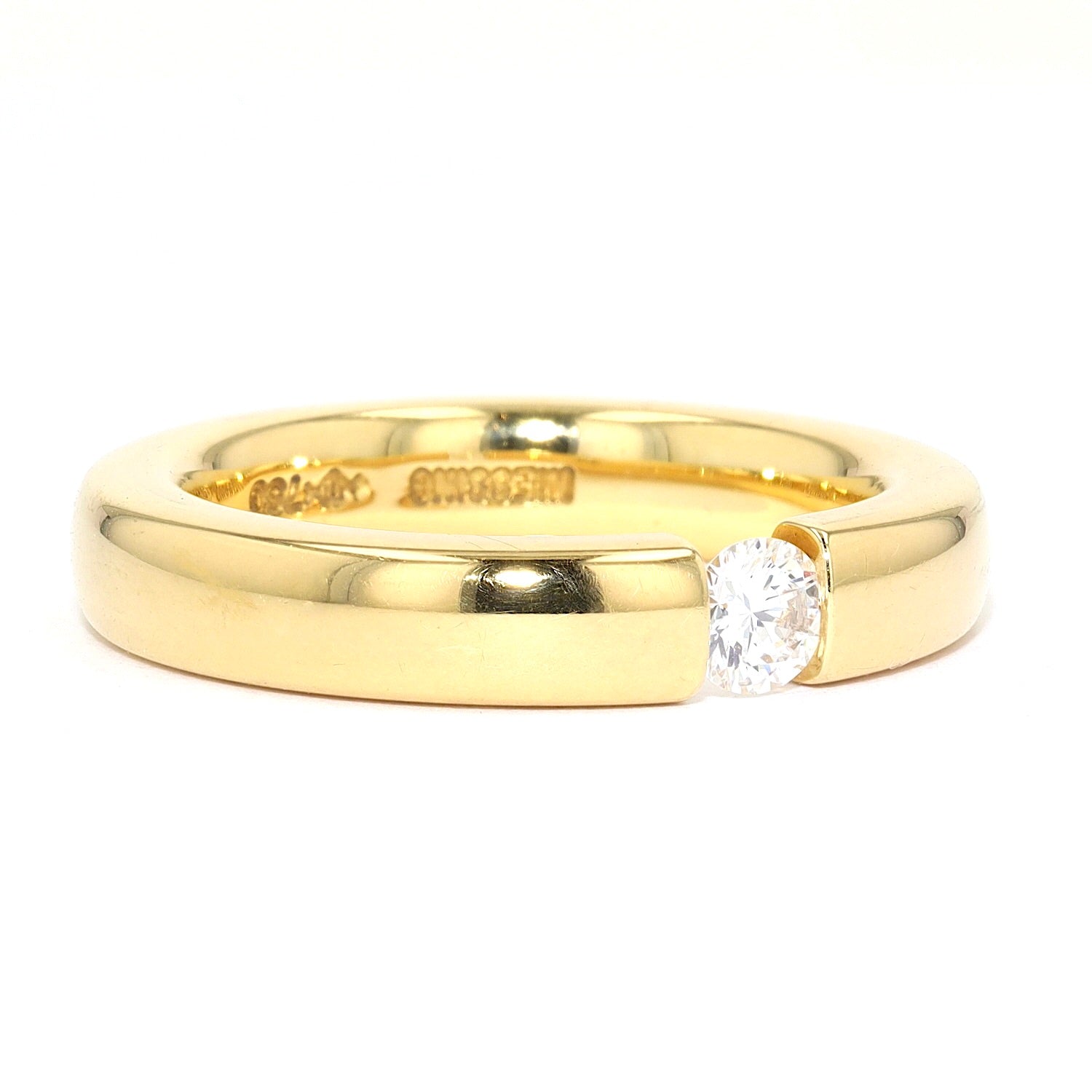 Niessing Spannring in 750er Gelbgold mit einem Brillanten ca. 0,20 ct, liegend rechts gedreht