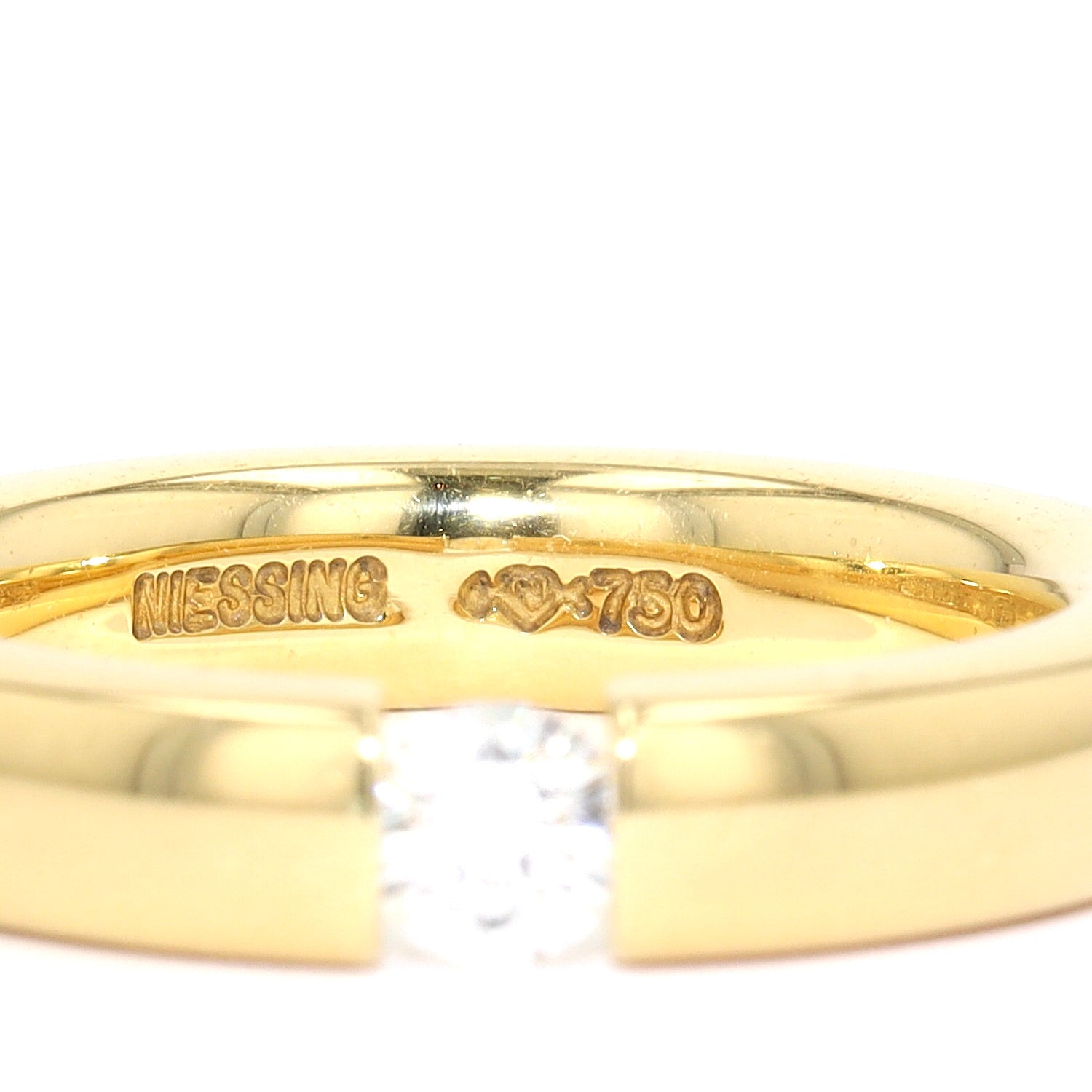 Niessing Spannring in 750er Gelbgold mit einem Brillanten ca. 0,20 ct, Gravur