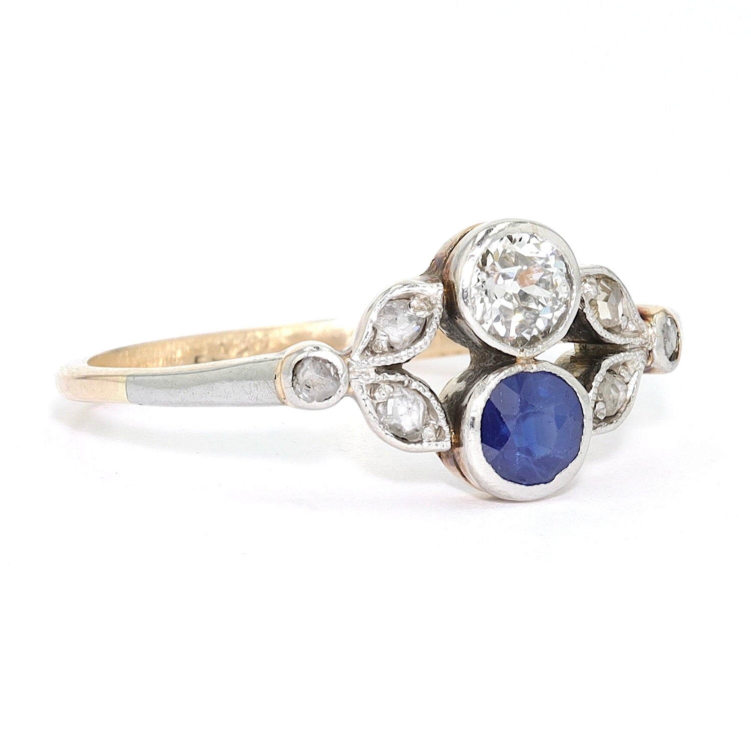 Antiker Ring um 1910 in 585er Gelbgold platiniert mit Diamanten und einem Saphir, liegend rechts gedreht