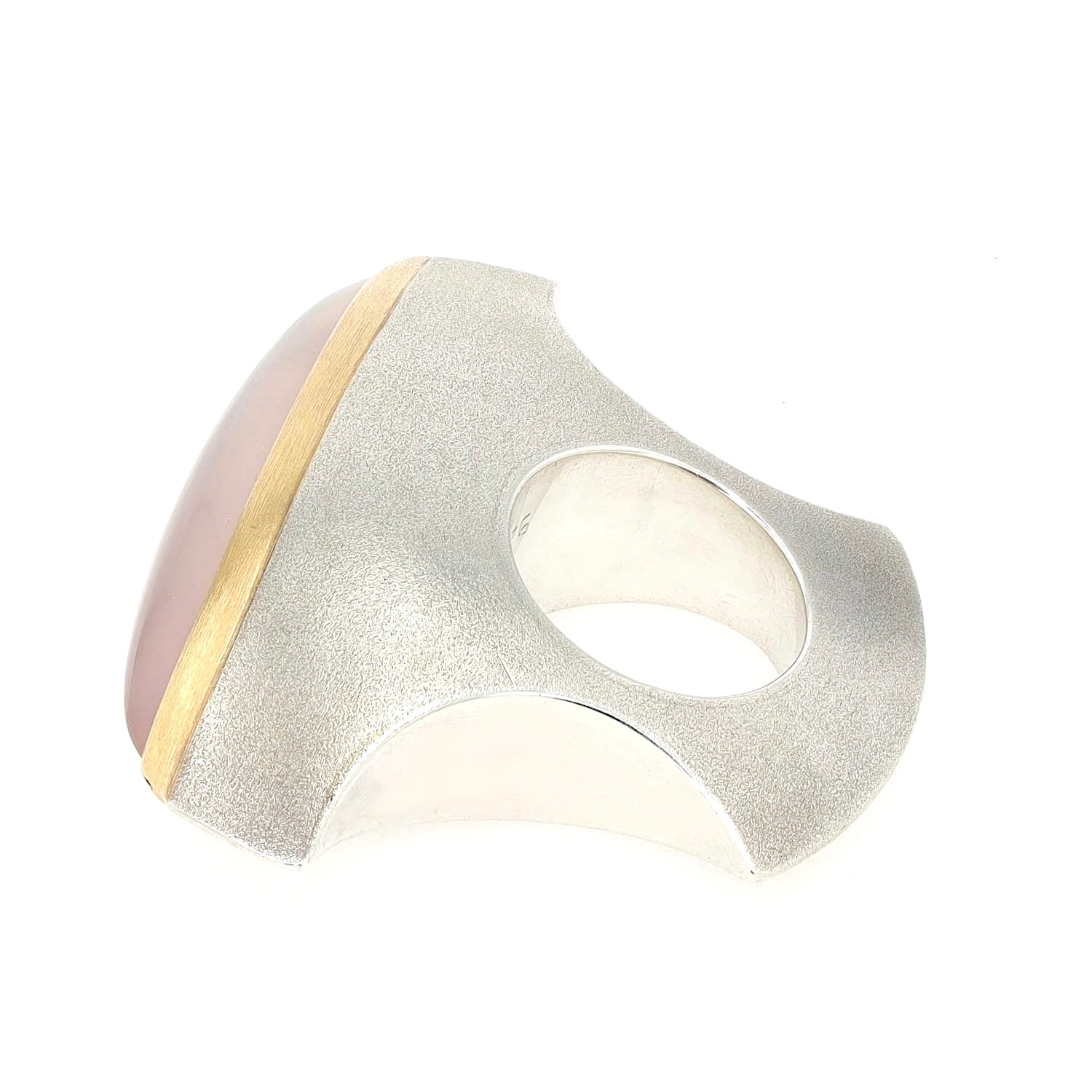 Designer Ring von Mike Mascher in 925er Silber und 750er Gelbgold mit einem rosa Quarz, liegend seitlich gedreht mit Sicht auf die Kerbe