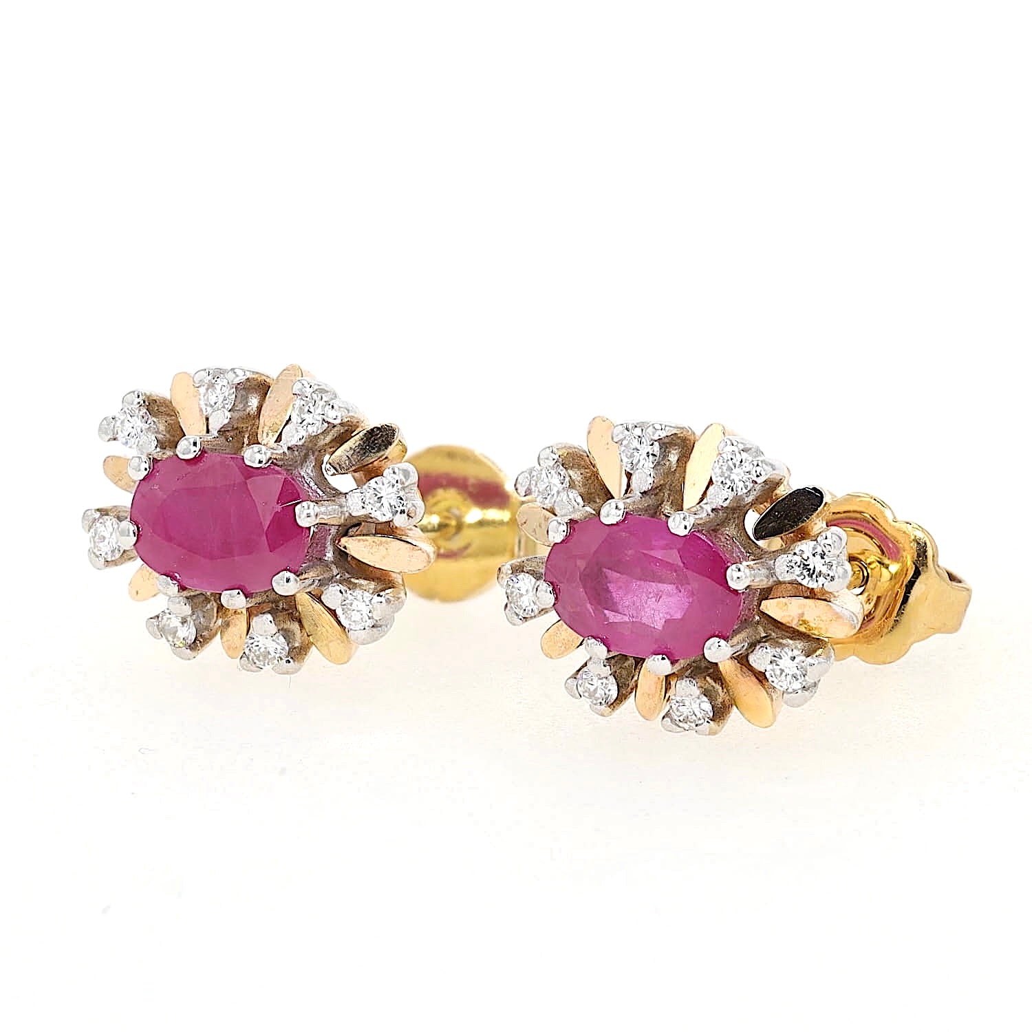 Stud earrings in 585 yellow and white gold with one each ruby and Brilliants, lying left turned