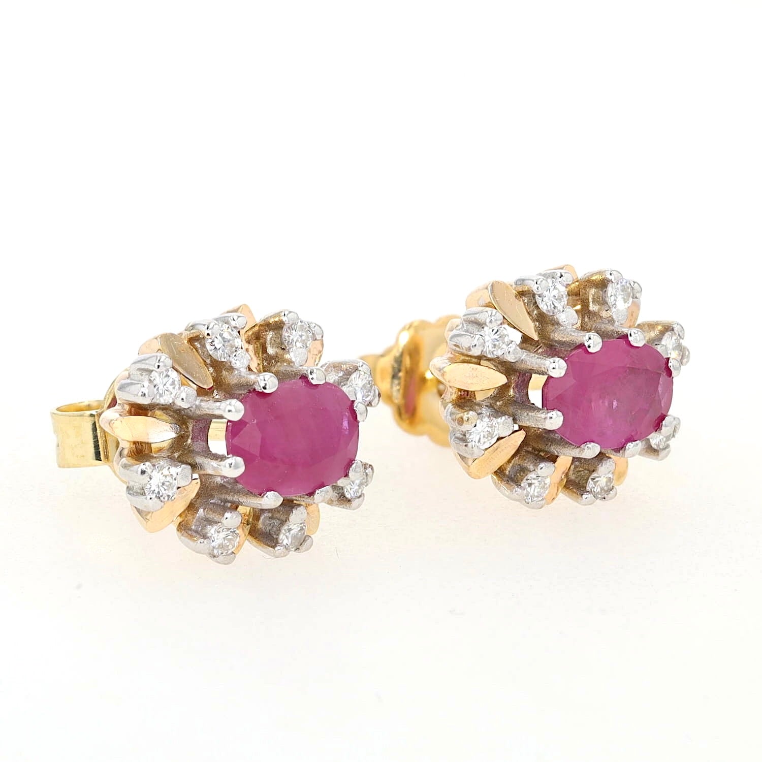 Stud earrings in 585 yellow and white gold with one each ruby and Brilliants, lying on the right