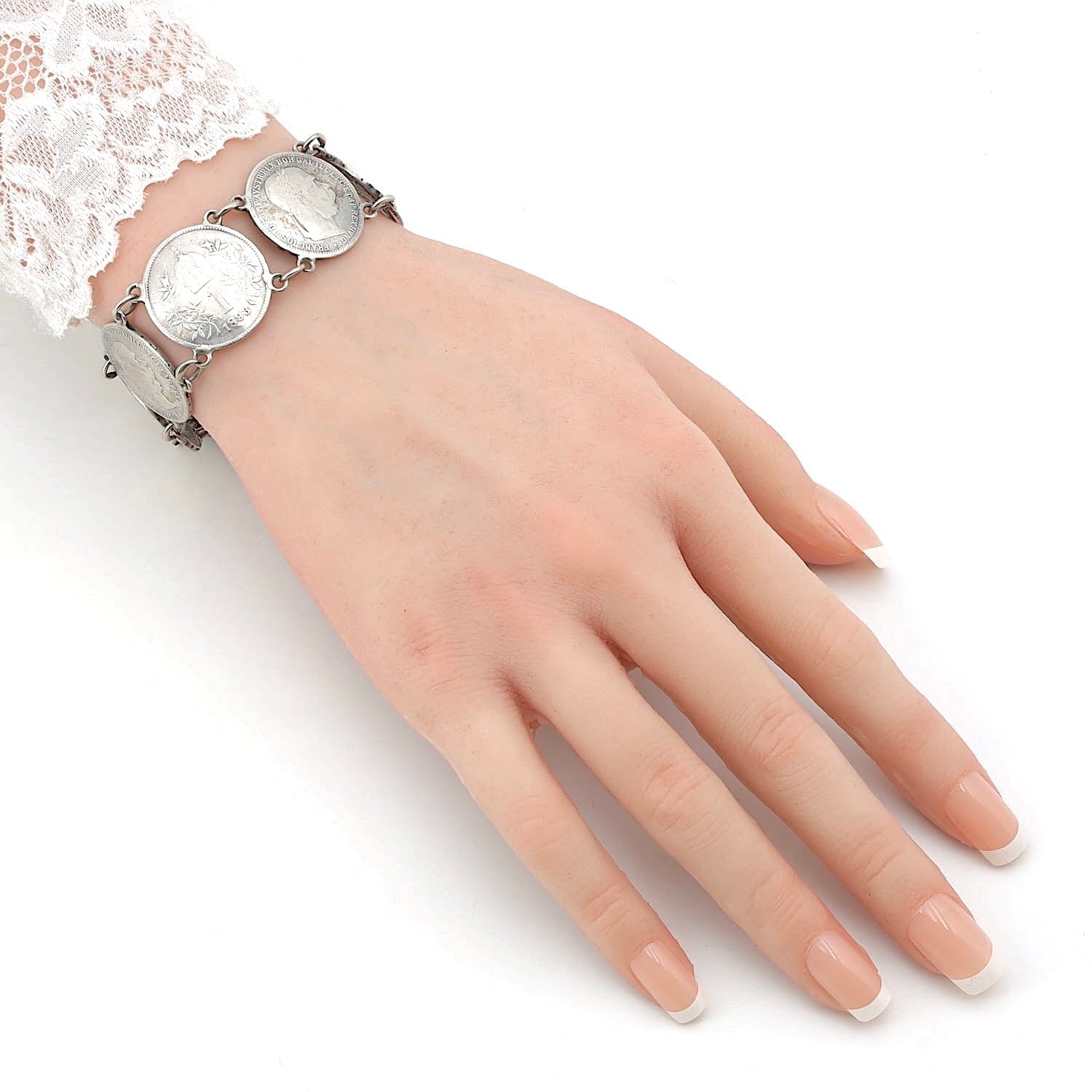 Antikes Münzarmband um 1920 mit 8 Kaiser Franz Joseph I. 1 Krone Münzen, an einem künstlichen Arm