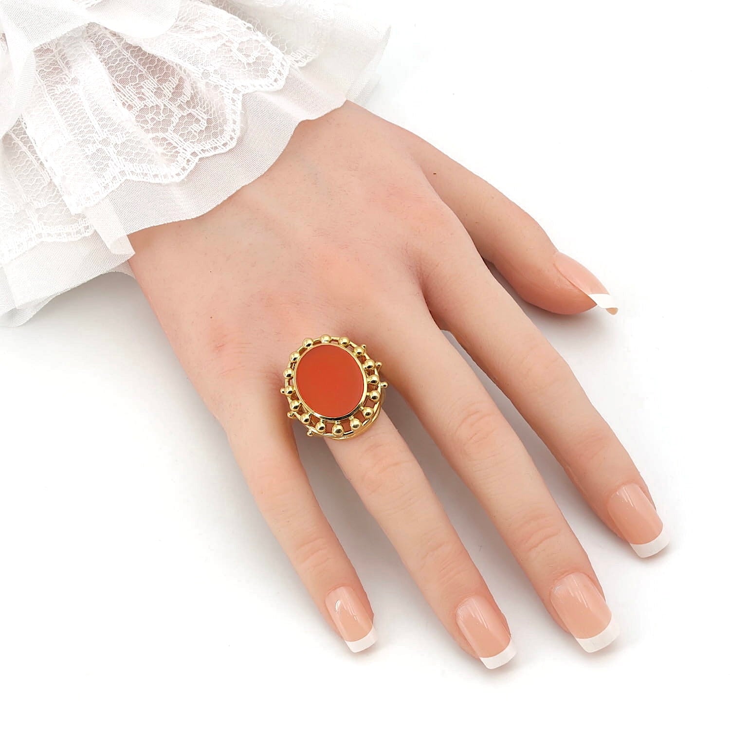 Ring in 750er Gelbgold mit einem Karneol, an einer künstlichen Hand