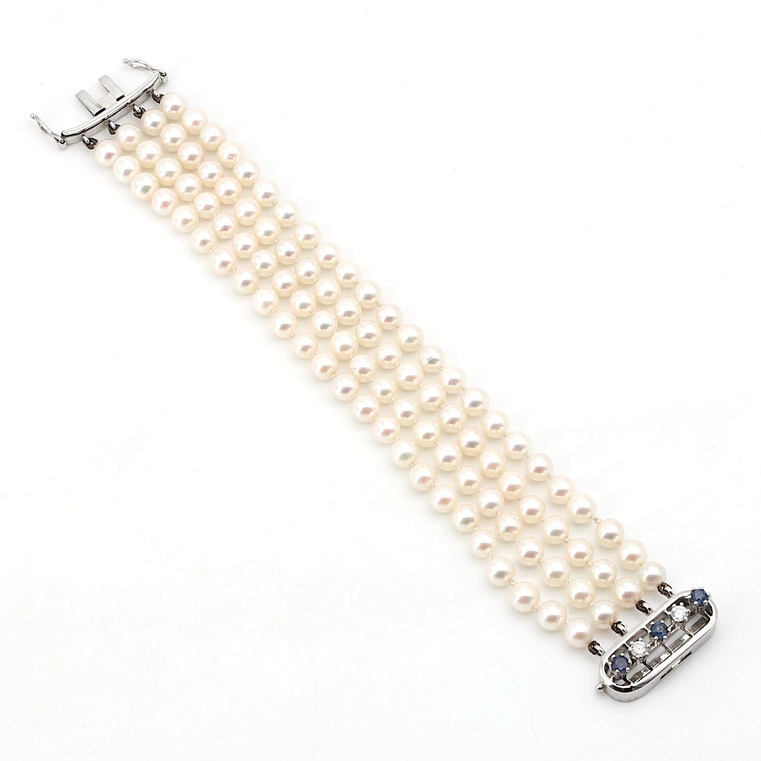 Armband aus 4 Reihen Zuchtperlen mit einem Schloß aus 585er Weißgold mit Saphiren und Brillanten, liegend längs