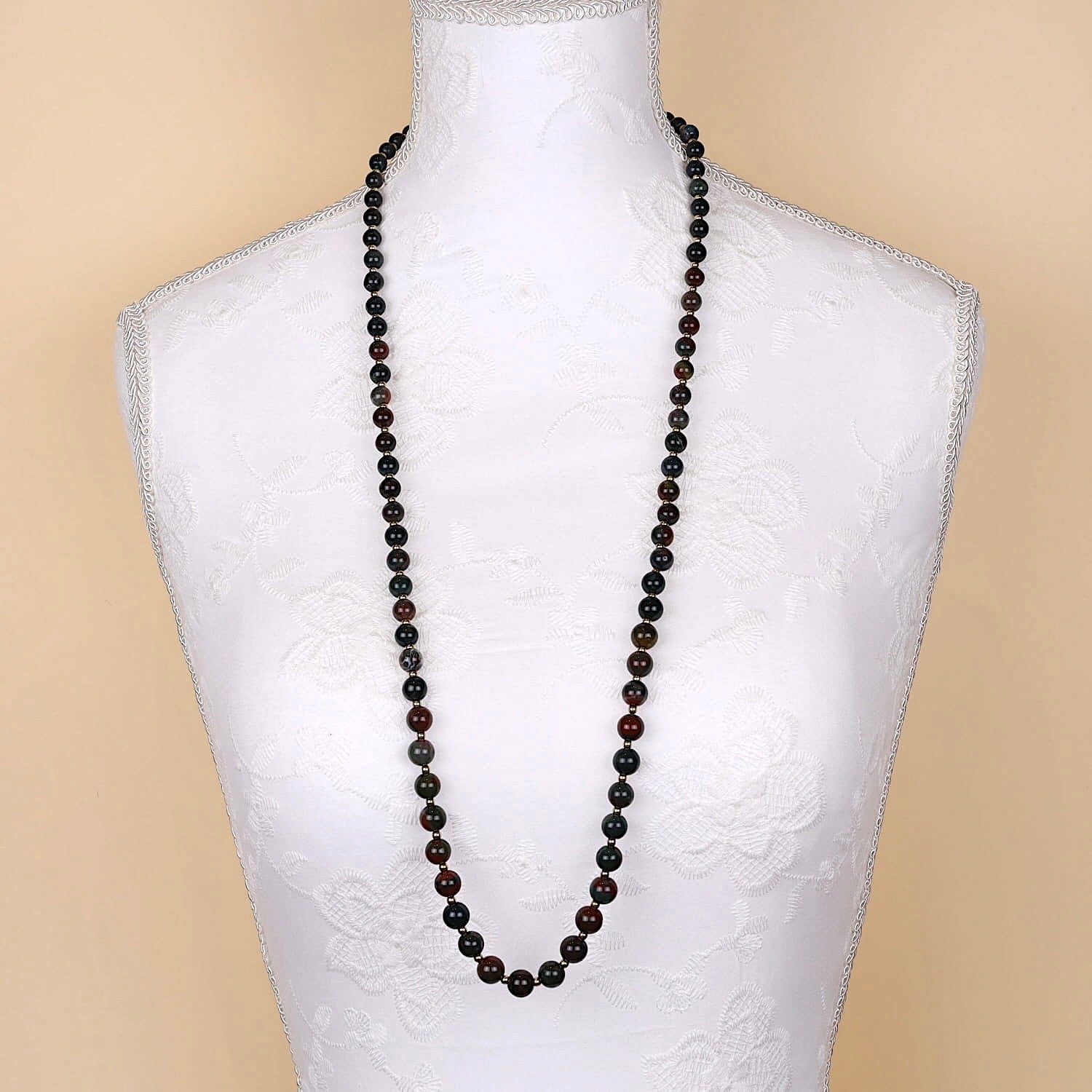 Long vintage gemstone necklace made of heliotrope spheres and gold-plated balls, long on a white bust
