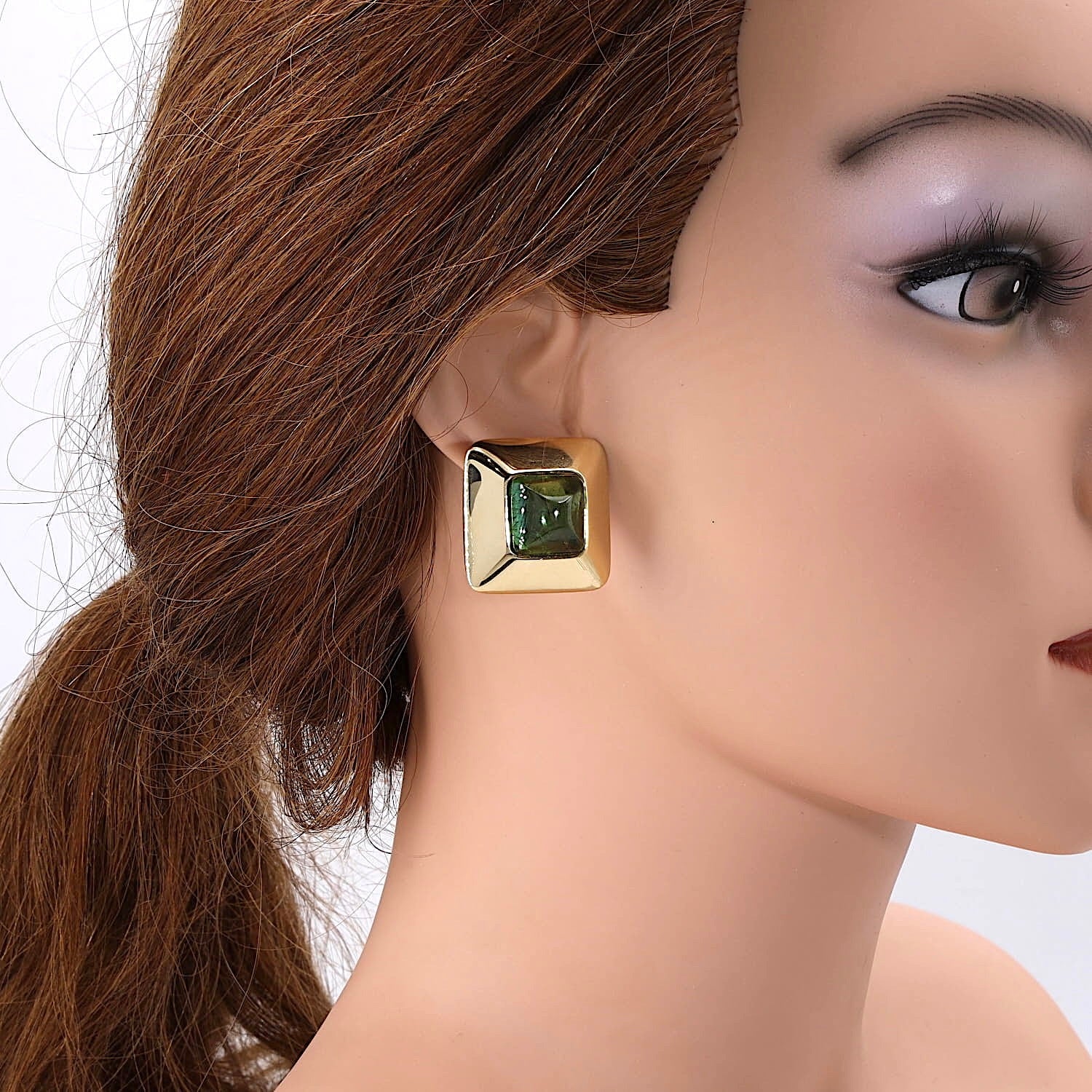 Stud earrings in 750 yellow gold, each with a tourmaline, on a doll