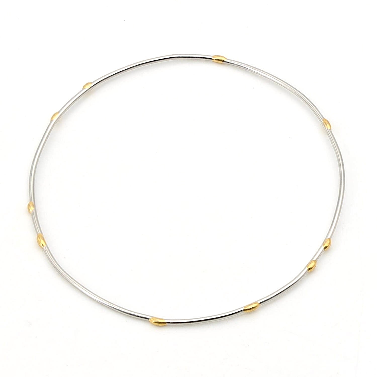 Armreif in 950er Platin mit goldenen Elementen, liegend rechts gedreht