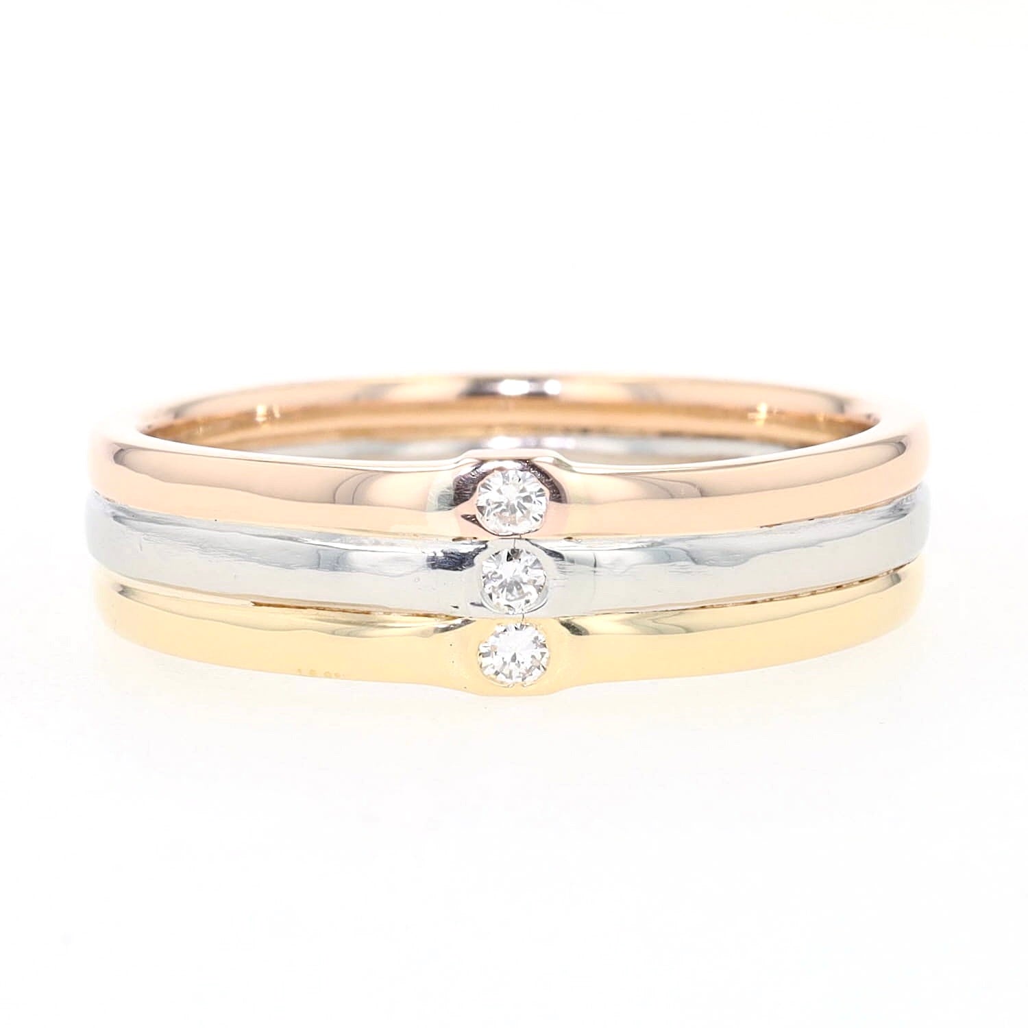 Niessing Ring Tricolor in zweifarbigen 750er Gold und Platin mit 3 Brillanten, liegend frontal