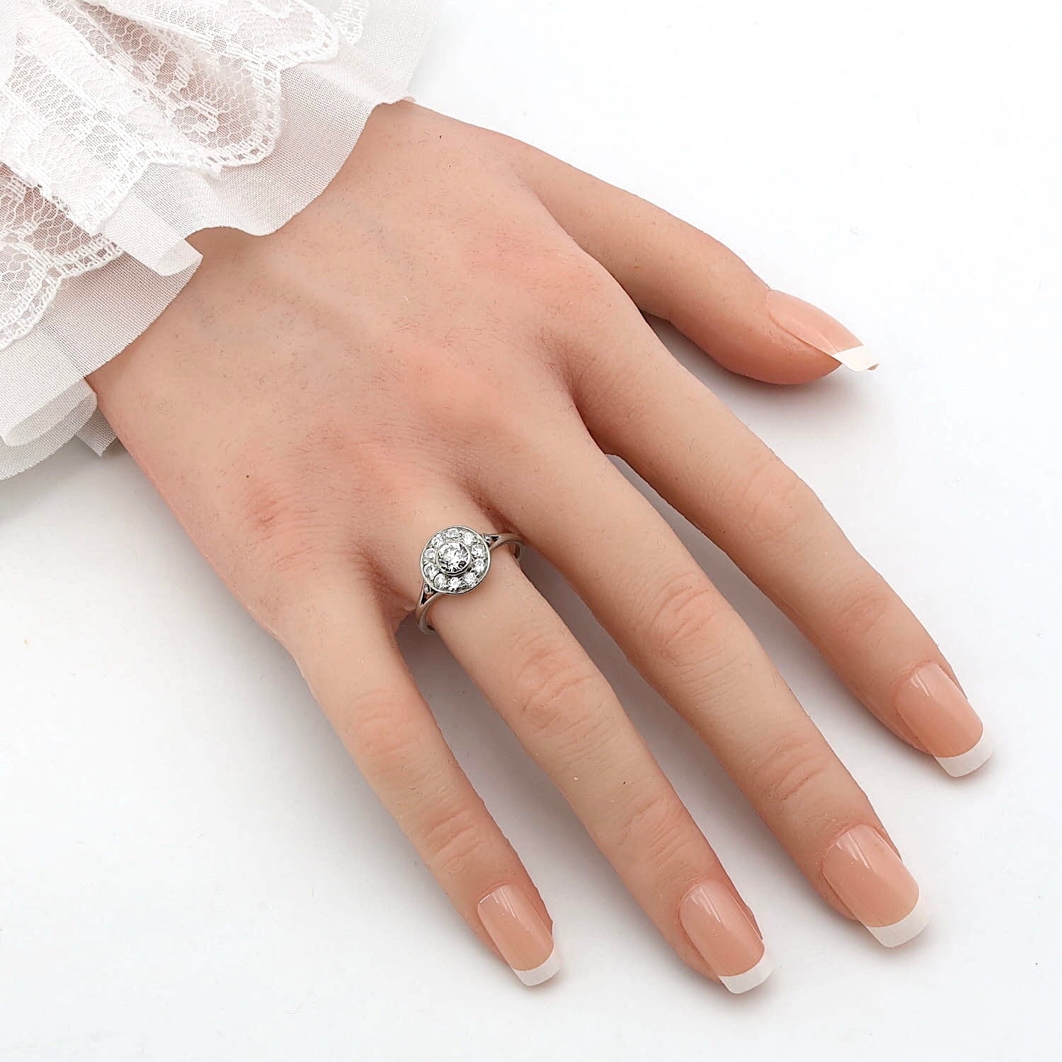 Art Deco target ring in platinum with a total of approx. 0.76 ct of diamonds, on an artificial hand