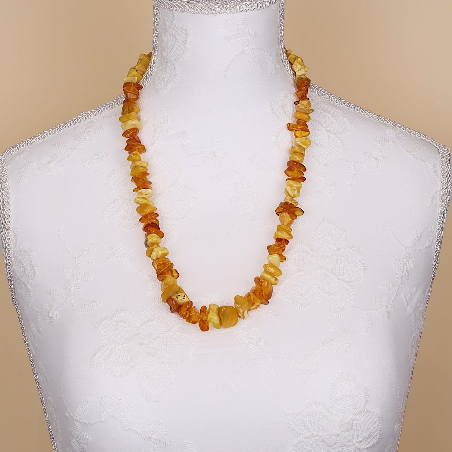 Amber necklace in the course, on a white bust