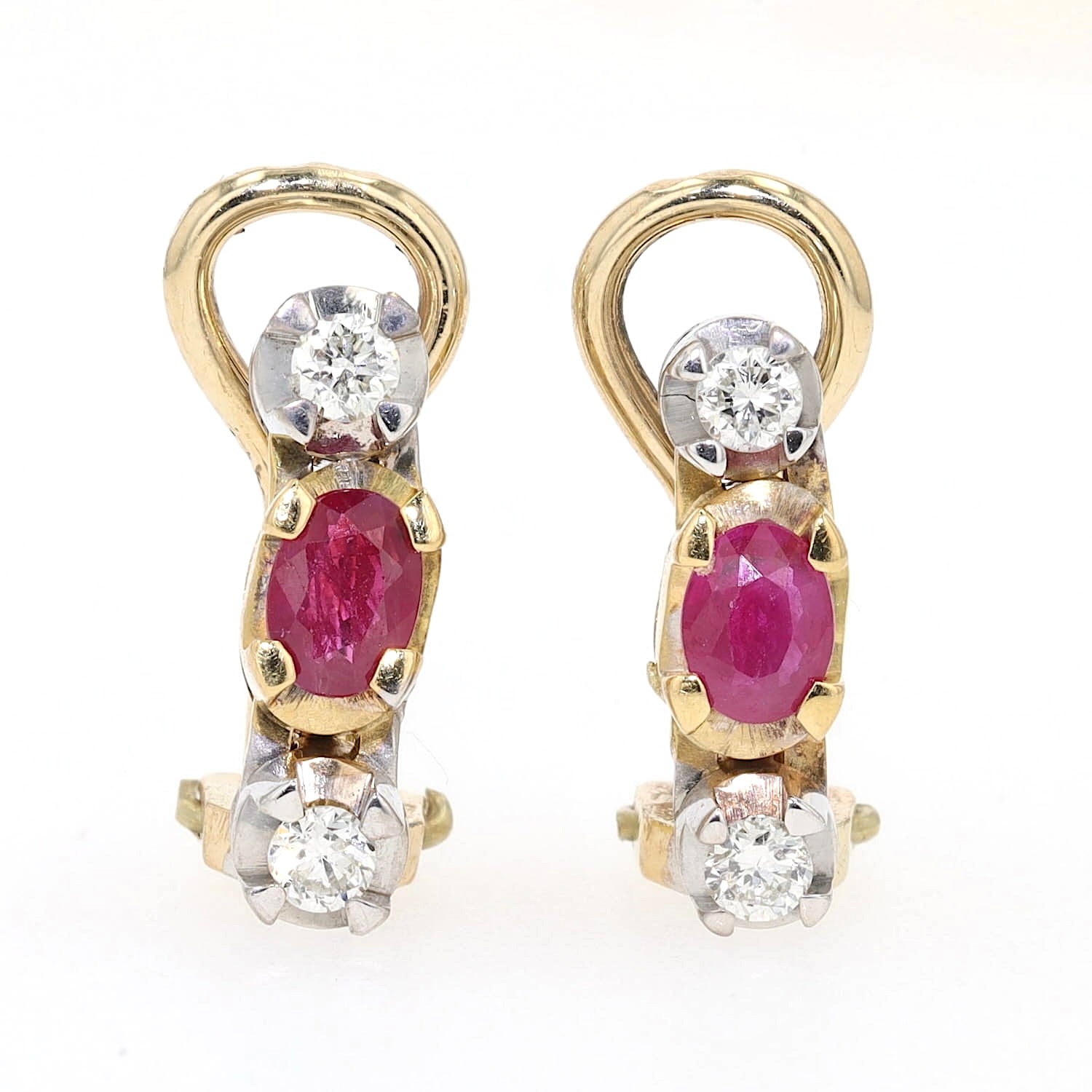 Pair of ear clips in 585 bicolor gold with one each ruby and Brilliants, standing frontally