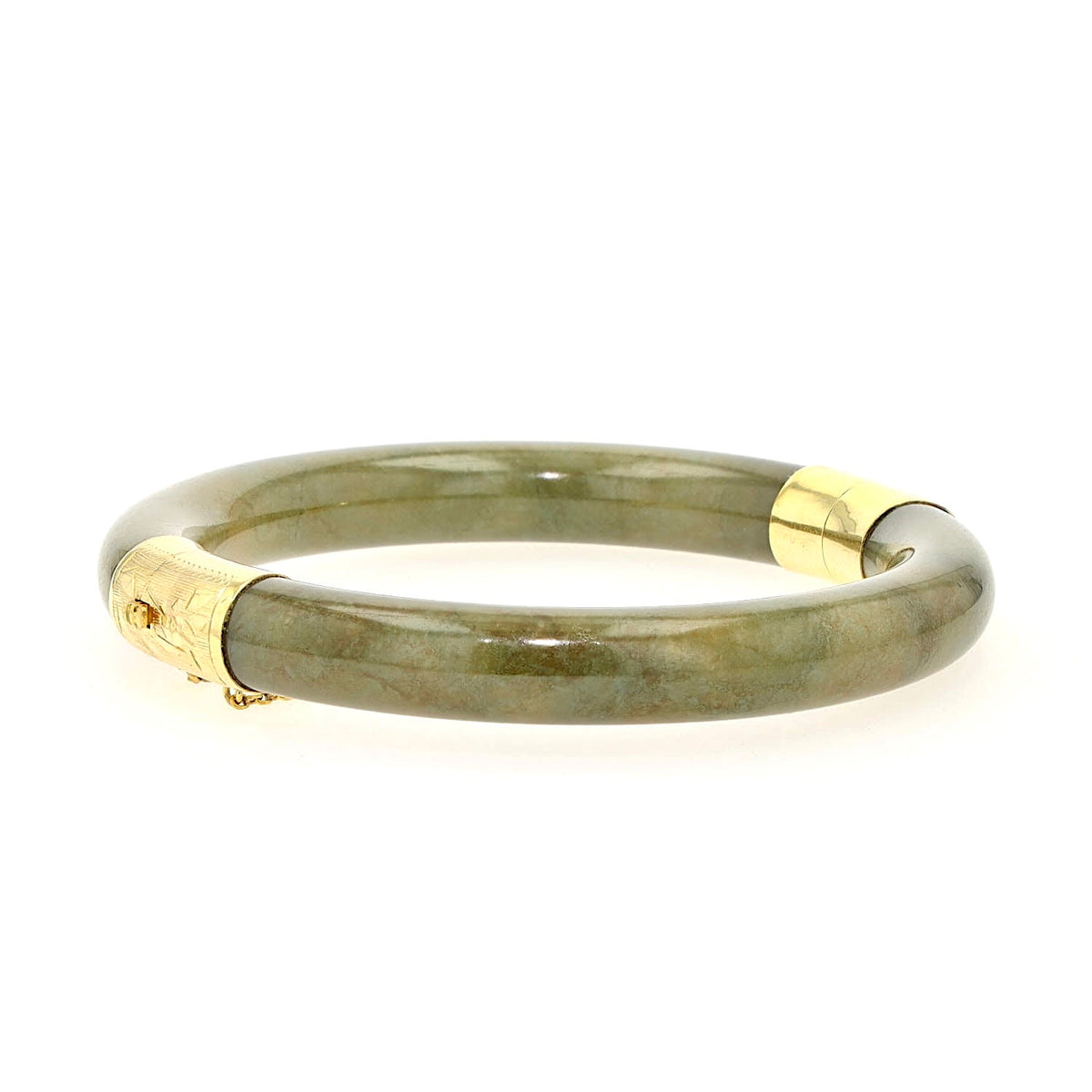 Bangle with jade elements and 585 yellow gold, lying frontally slightly turned to the right