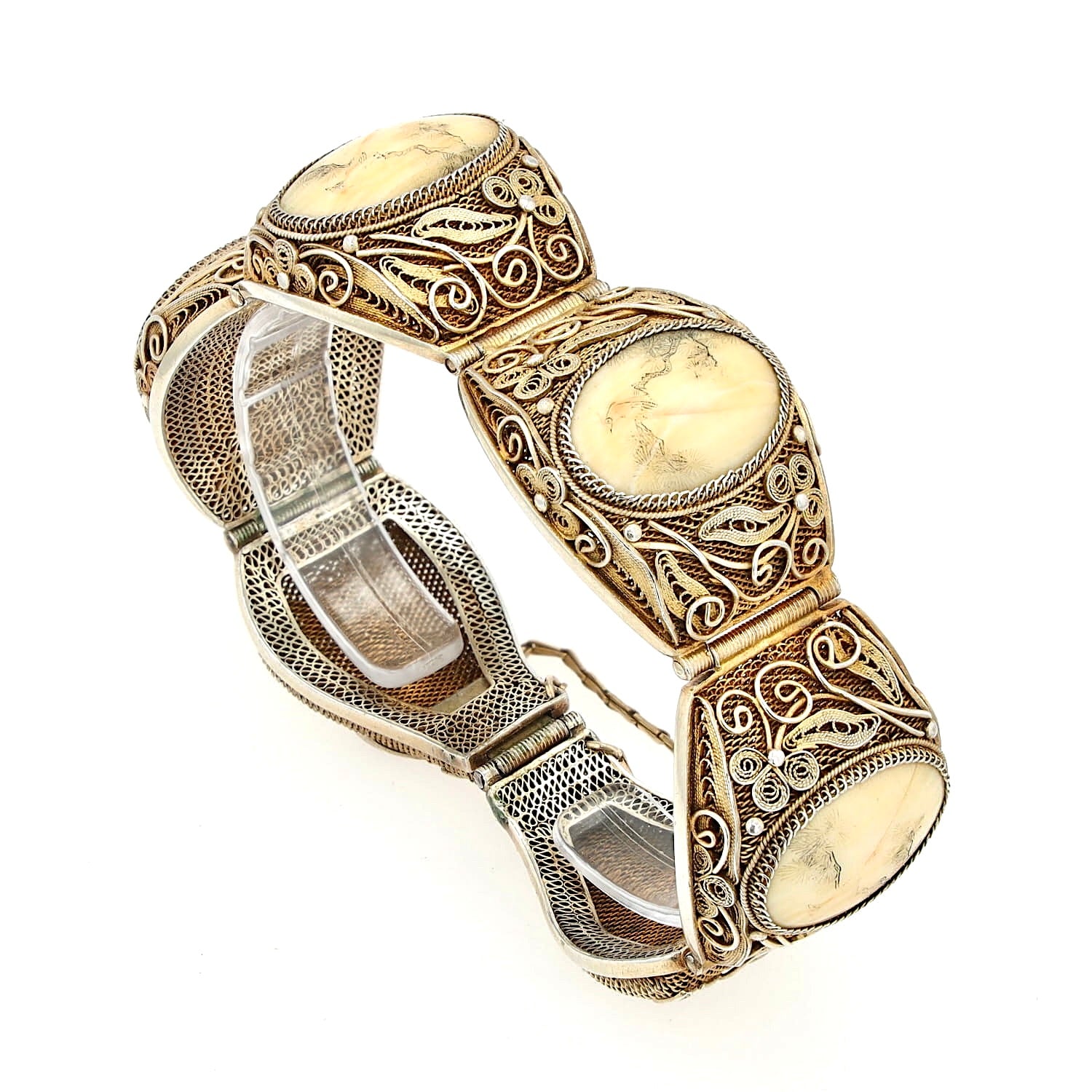 Chinese bracelet from around 1900 in silver, gold-plated with bone, standing on a plastic holder, closed and slightly turned to the right
