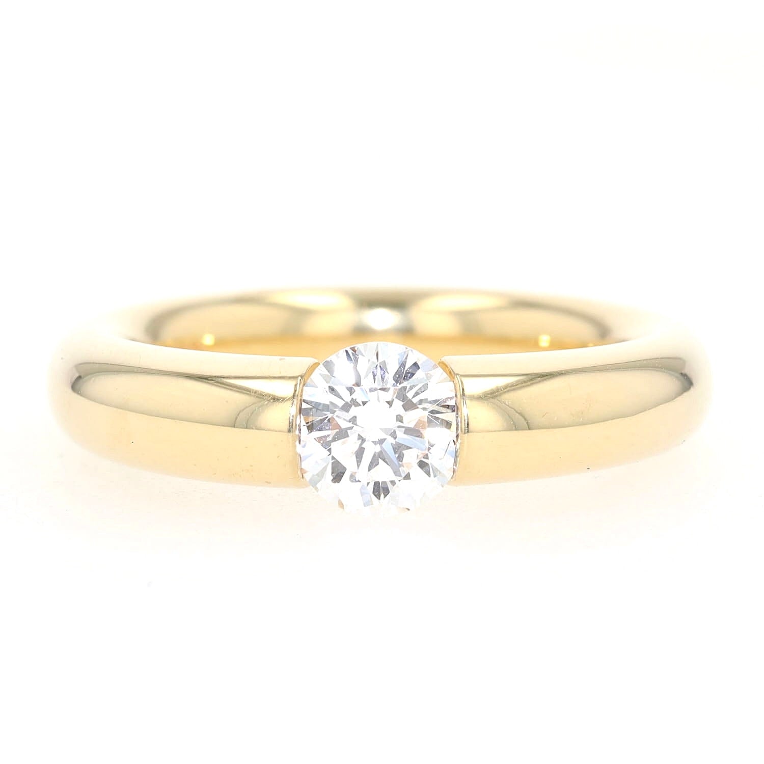Niessing Spannring in 750er Gelbgold mit einem Brillanten ca. 1,0 ct, liegend frontal