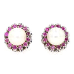 Stud earrings in 750 white gold with one each cultured pearl and rubies, lying frontally