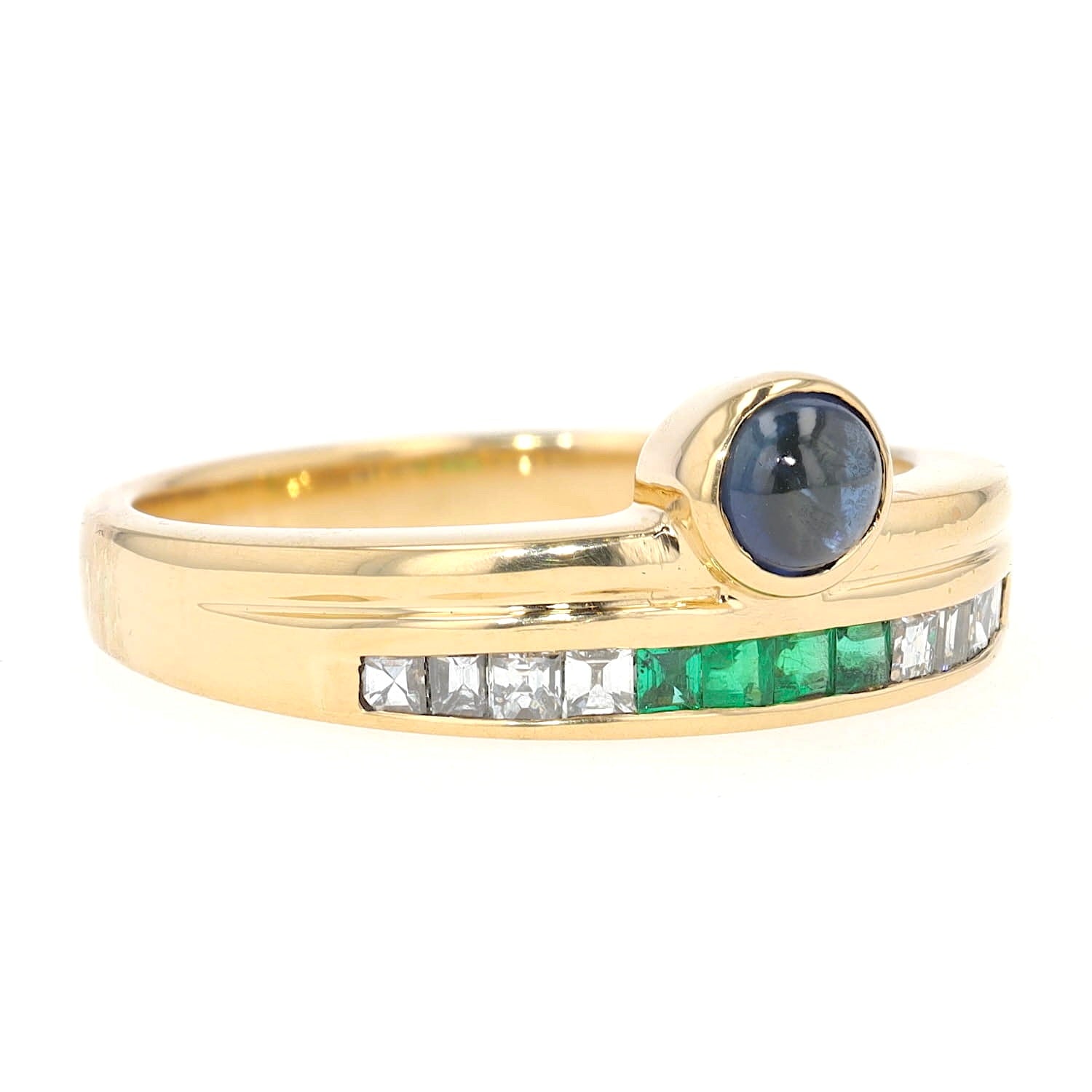 Buchwald ring in 750 yellow gold with diamonds, emeralds and a sapphire cabochon