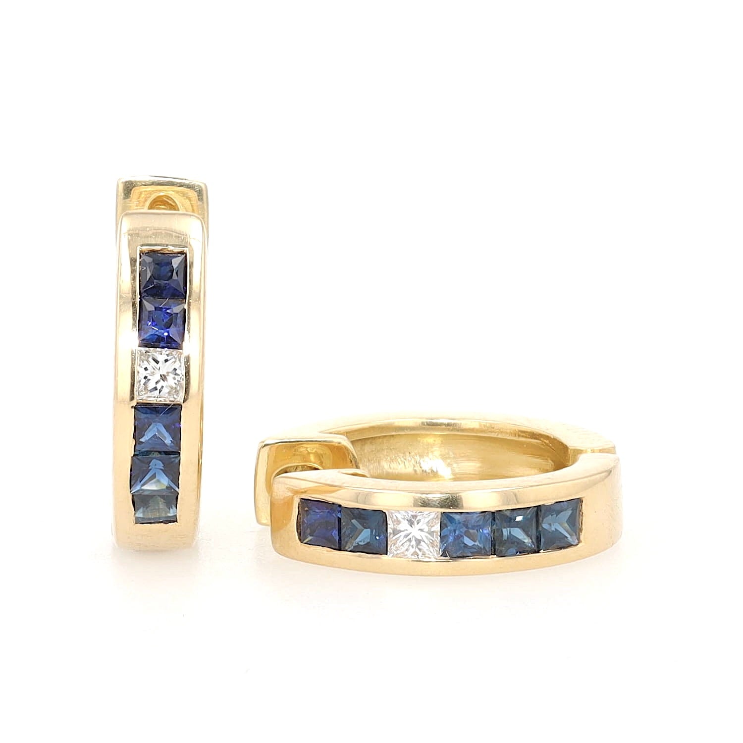 A pair of creoles in 750 yellow gold with diamonds and sapphires, one standing, one lying frontally