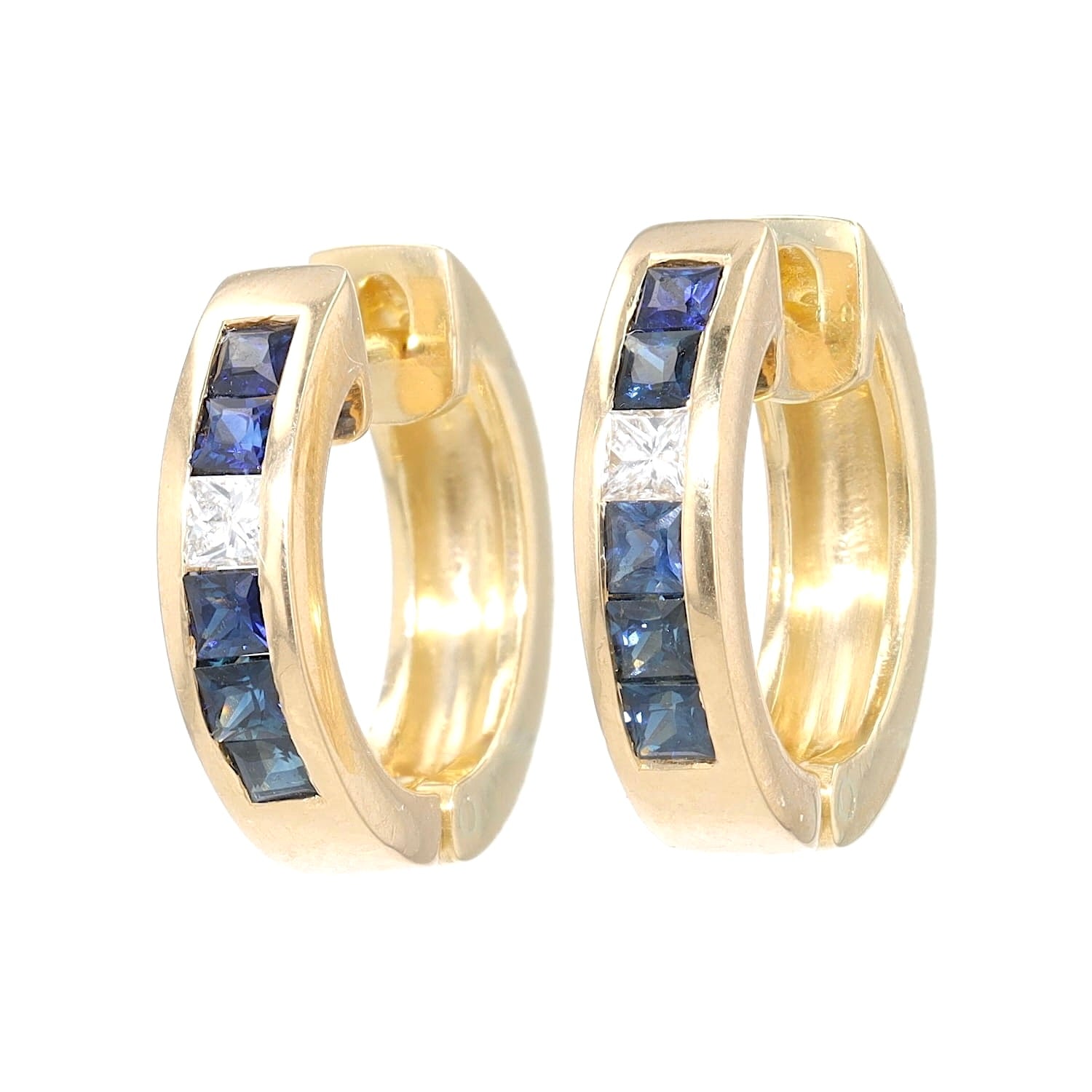 A pair of creoles in 750 yellow gold with diamonds and sapphires, standing frontally slightly tilted to the side