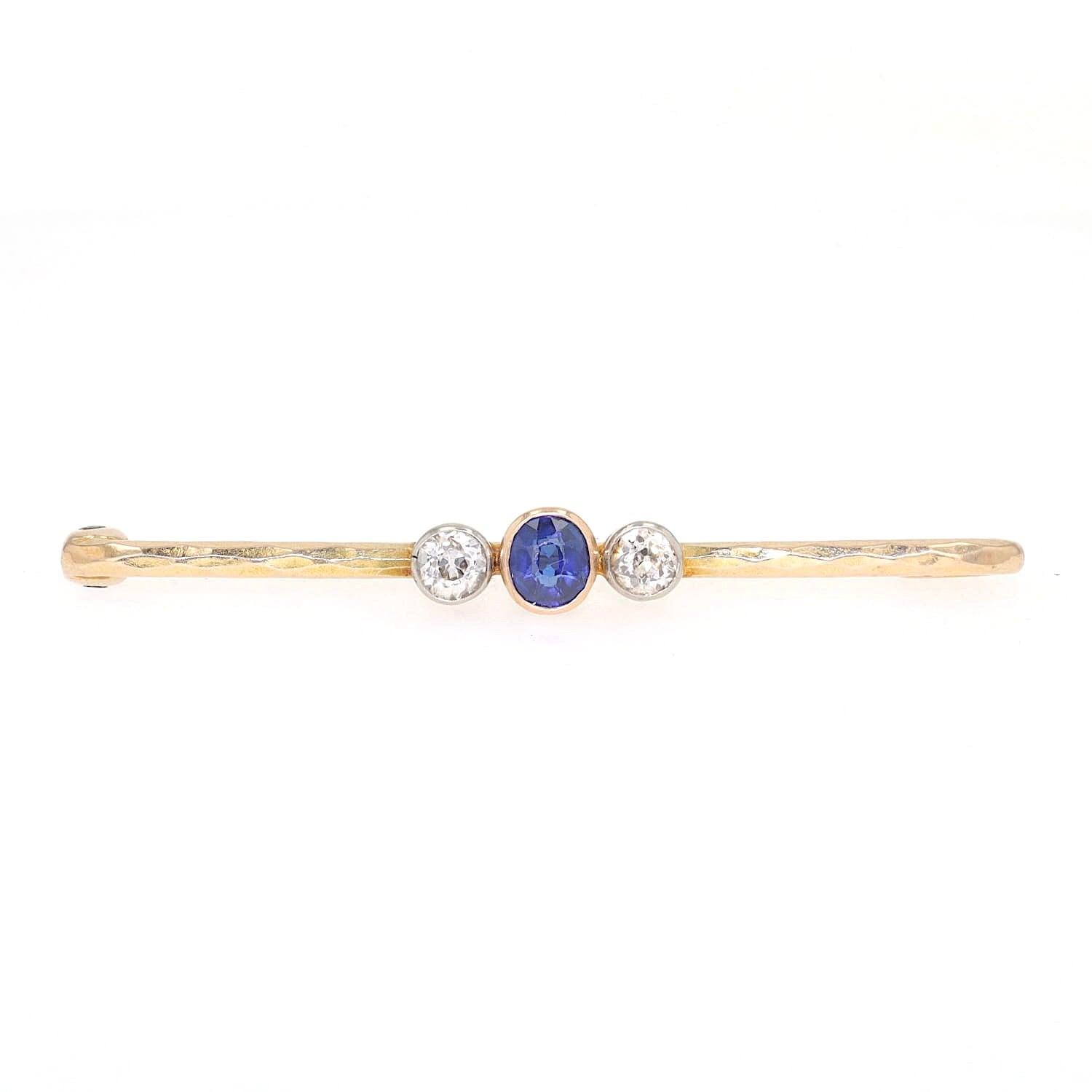 Vintage pin in 585 yellow gold with diamonds and a sapphire, lying frontally