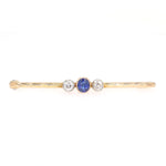 Vintage pin in 585 yellow gold with diamonds and a sapphire, lying frontally