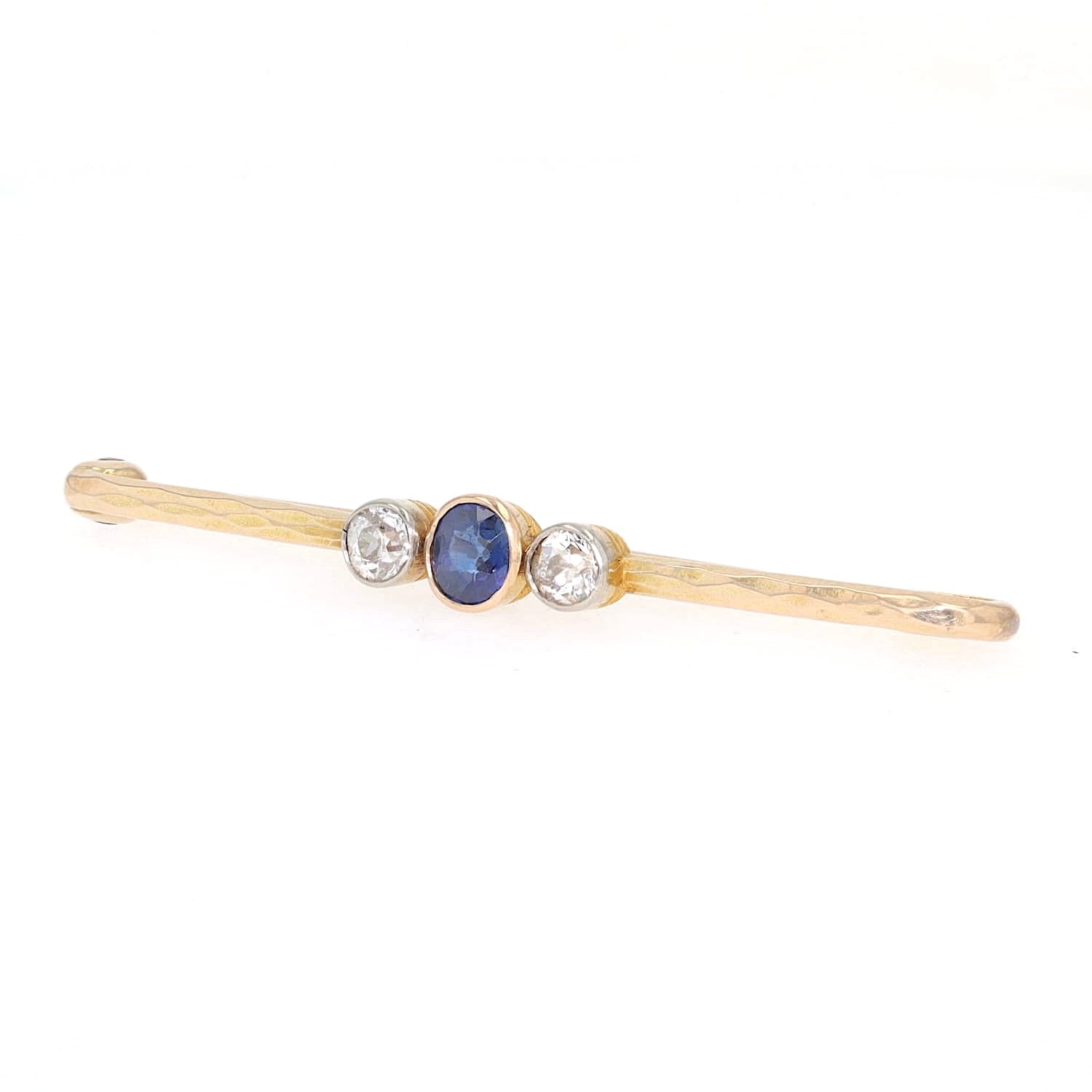 Vintage pin in 585 yellow gold with diamonds and a sapphire, turned horizontally to the left