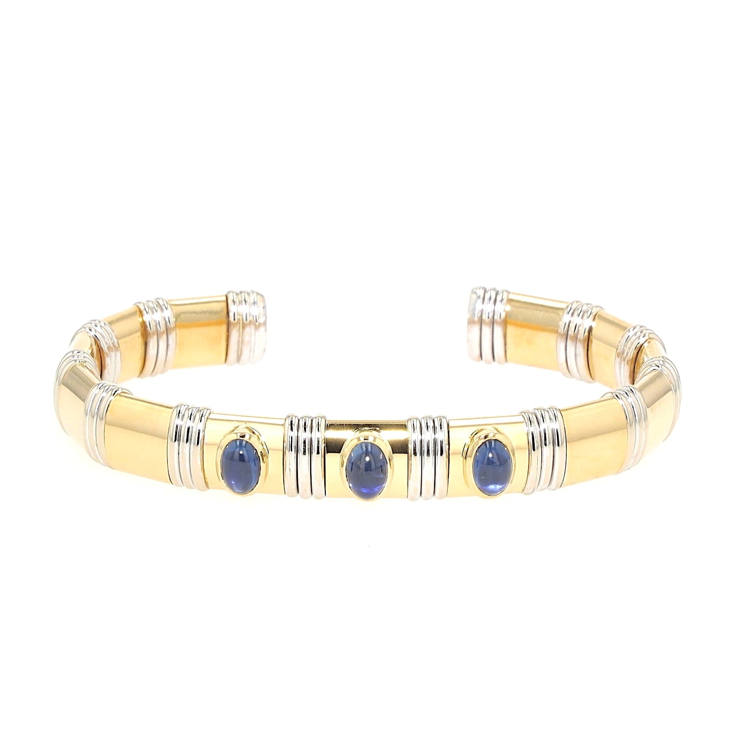 Bangle in 750 yellow and white gold with sapphire cabochons, lying frontally