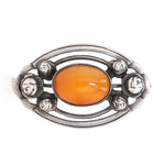 Jugendstil Brosche in 800er Silber mit einem Butterscotch Bernstein, liegend frontal