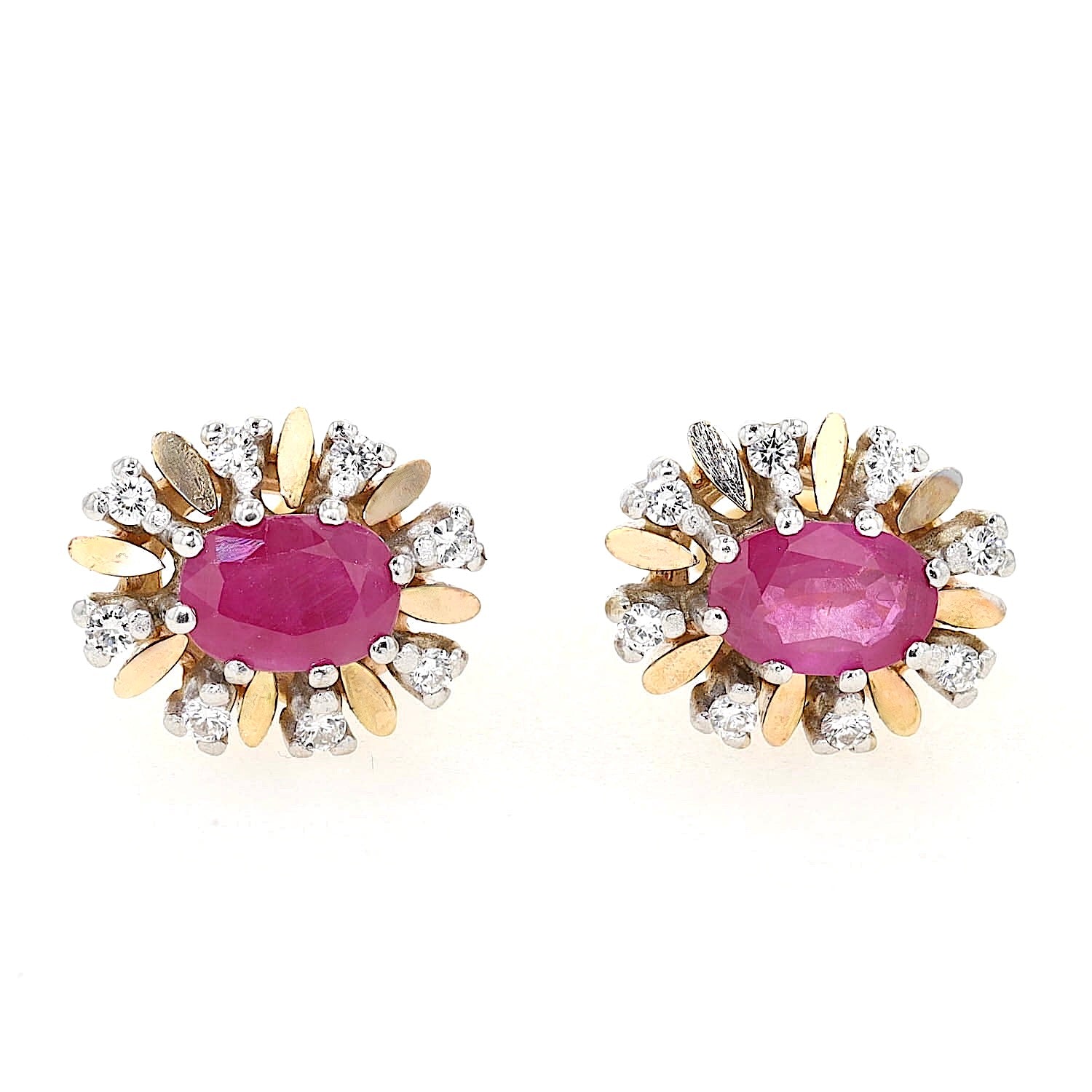 Stud earrings in 585 yellow and white gold with one each ruby and Brilliants, lying frontally