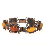 Bracelet made of copper with amber, lying frontally