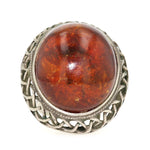 Statement ring silver plated with a large amber, lying frontally