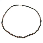Long vintage gemstone necklace made of heliotrope spheres and gold-plated balls, closed lying down