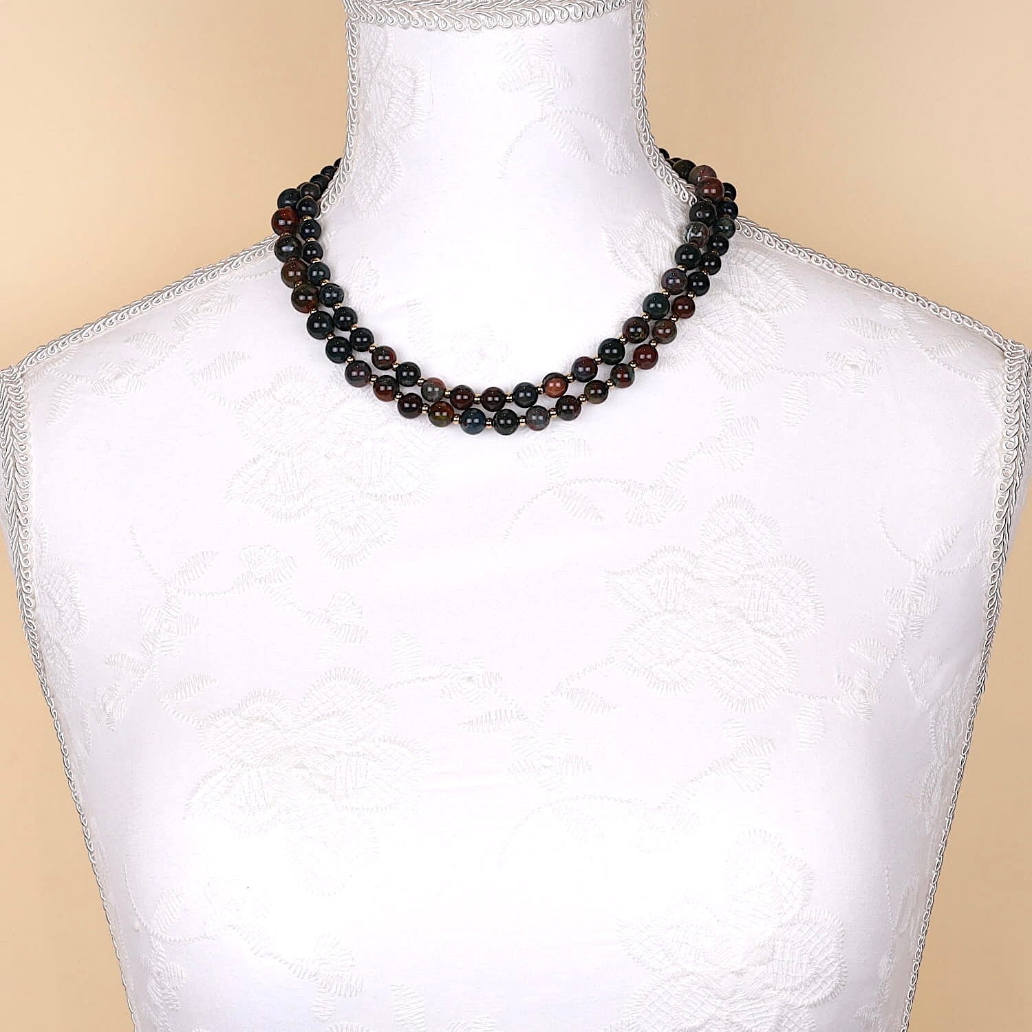 Long vintage gemstone necklace made of heliotrope spheres and gold-plated balls, doubled on a white bust