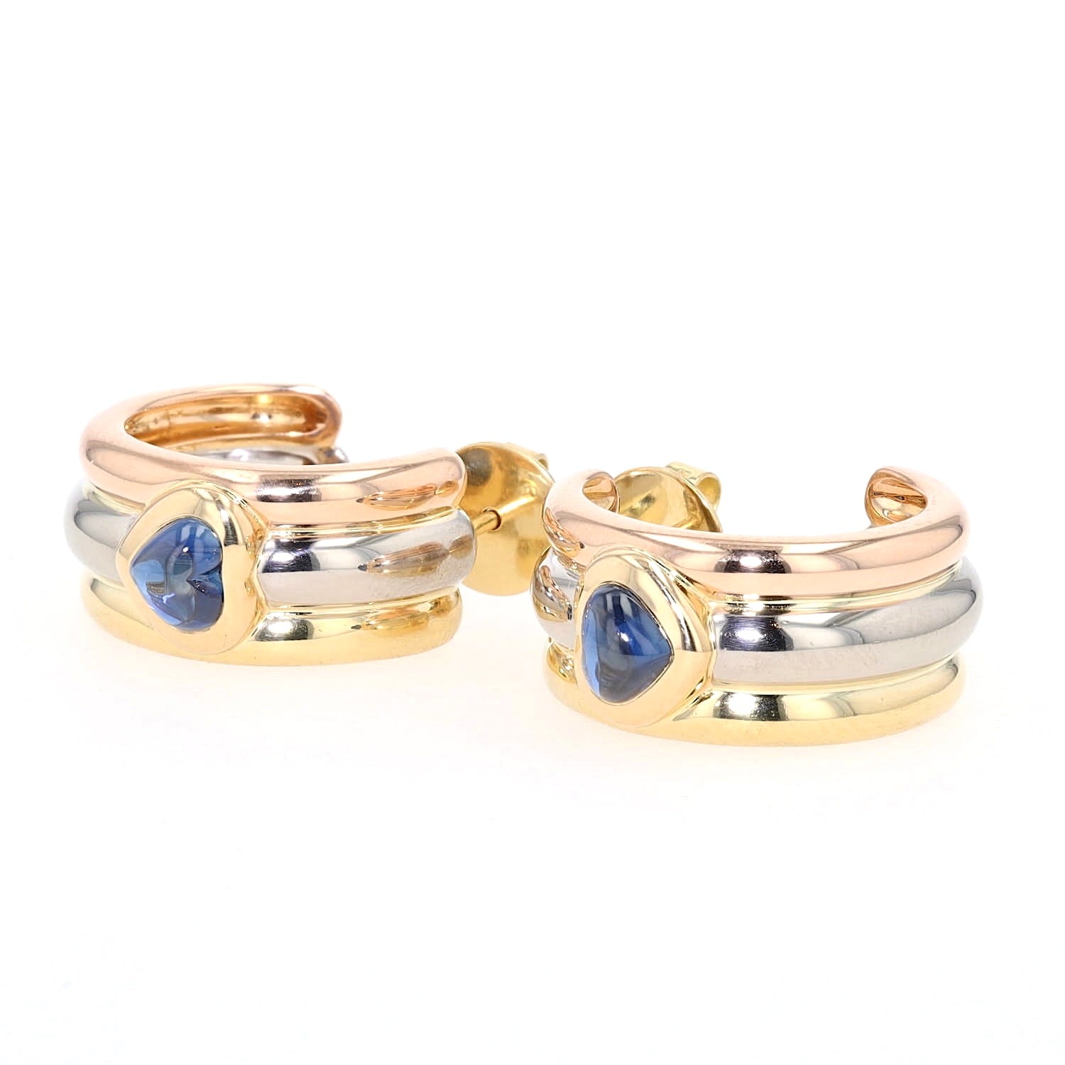 Chopard half hoop earrings in 750 Trivcolor gold, each with a blue sapphire cabochon, turned left-handed