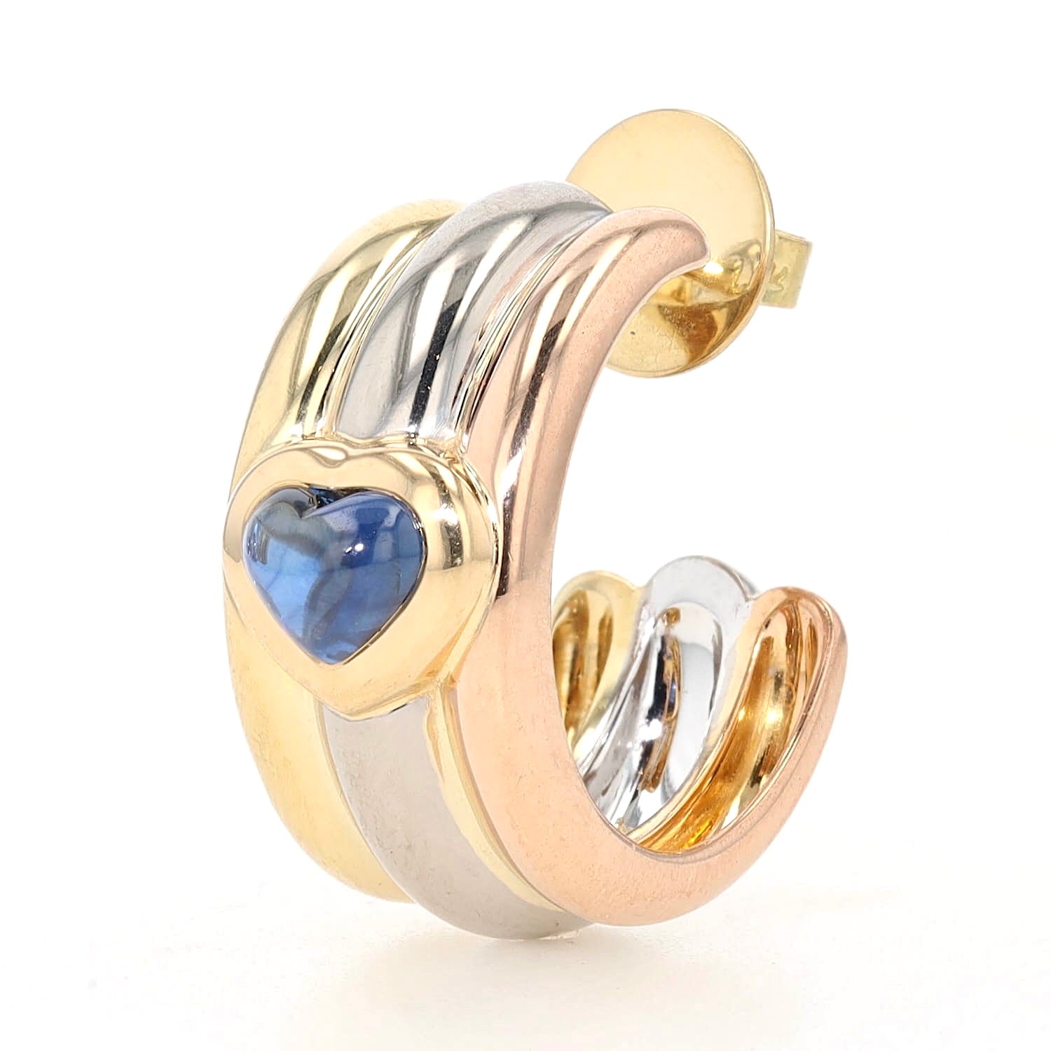 Chopard half hoop earrings in 750 Trivcolor gold, each with a blue sapphire cabochon, one earring standing slightly turned to the left
