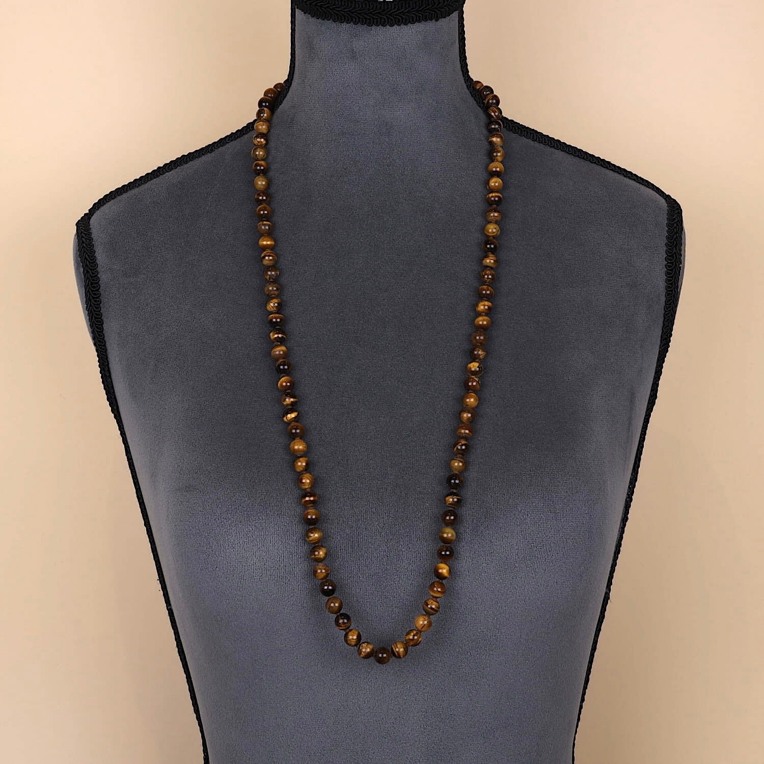 Long endless chain with tiger eye balls on a dark bust