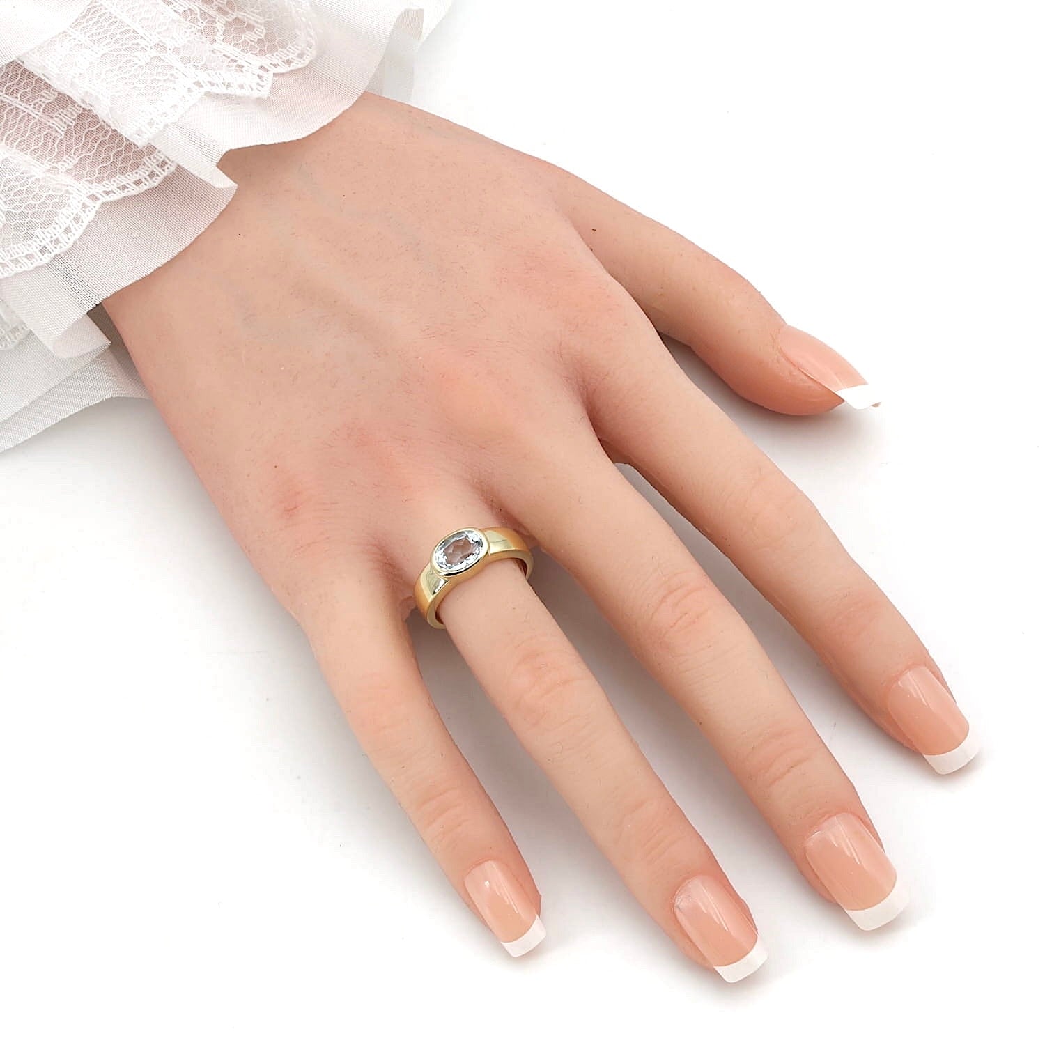 Ring in 585er Gelbgold mit einem Aquamarin, an einer künstlichen Hand
