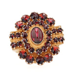 Ring made of 900 silver, gold-plated with garnets, lying frontally