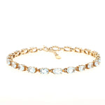 Bracelet made of gold-plated 925 silver with blue topazes, lying closed at the front