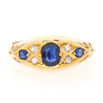 Edwardian ring in 750 yellow gold with blue sapphires and diamonds, lying frontally