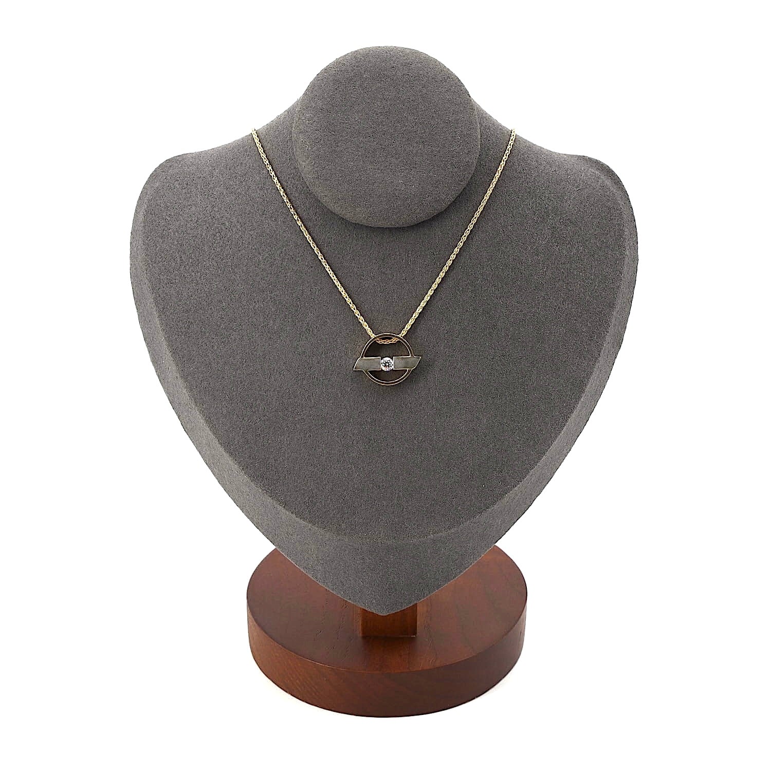 Chain in 750 yellow gold with a pendant in 750 yellow and white gold with a brilliant, on a dark bust