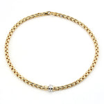 Fope Eka Flex`it necklace in 750 yellow gold with a roundel in white gold Brilliants, lying closed