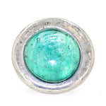 Statement ring made of pewter with a green glass stone, lying frontally