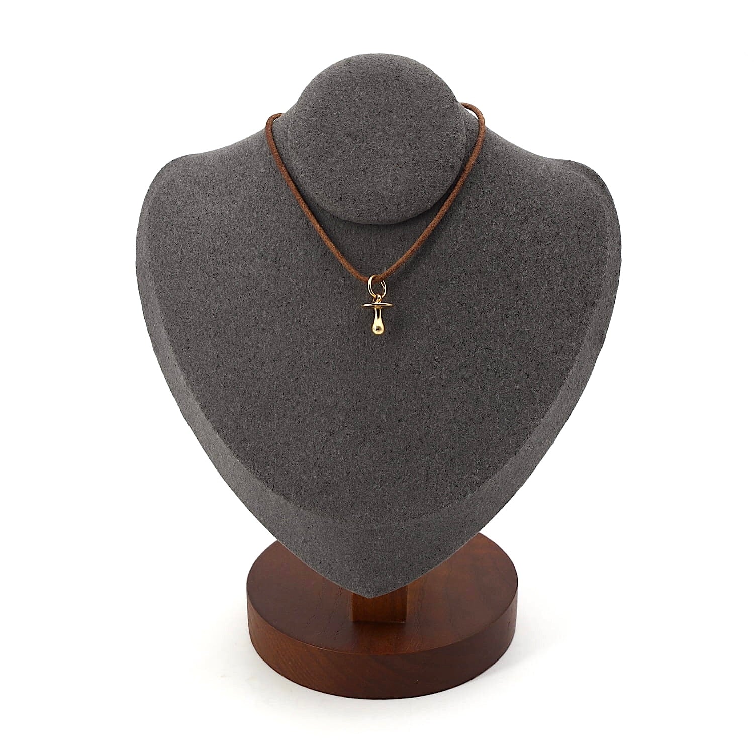 Pendant made of 750 yellow gold in the shape of a pacifier, on a dark bust