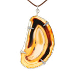 Large pendant made of agate set in metal, hanging from the front