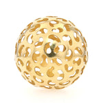 Niessing pendant in the shape of a ball made of 750 yellow gold, lying frontally