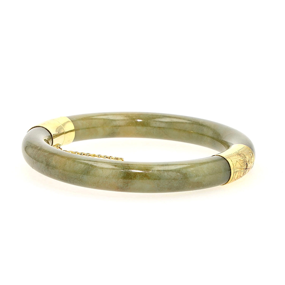 Bangle with jade elements and 585 yellow gold, lying frontally slightly turned to the left