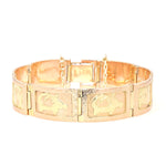 Vintage bracelet in 585 red gold with various motifs, lying frontally